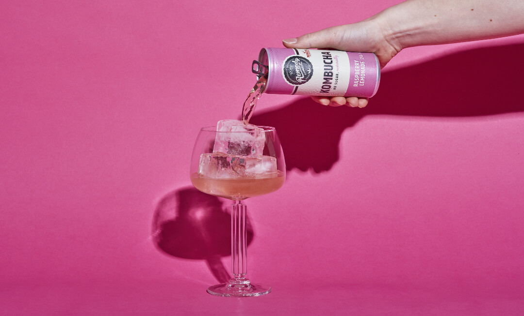 Remedy Kombucha Raspberry Lemonade being poured into a glass