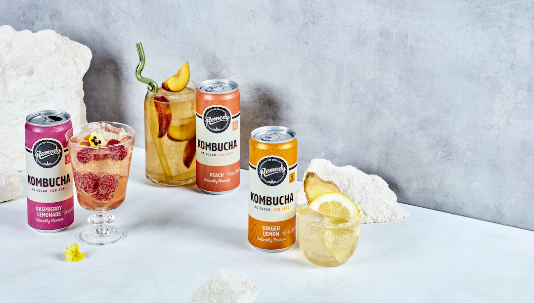 Remedy Kombucha flavors Peach, Ginger Lemon, and Raspberry lemonade in glasses with fruit garnishes