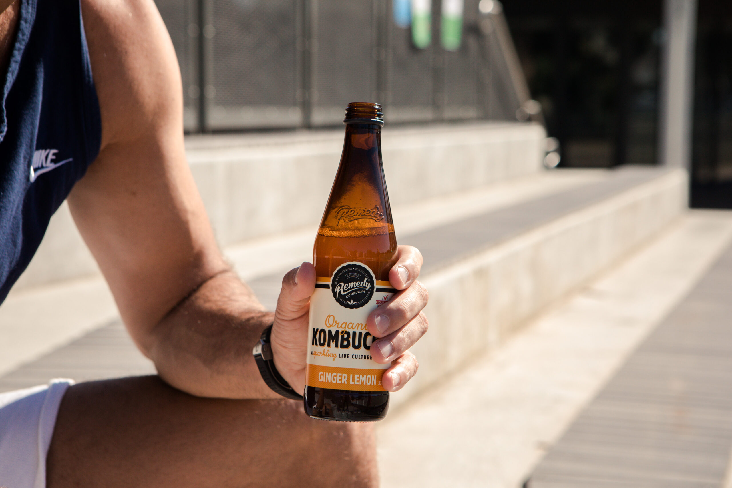 Man Holding Remedy Kombucha Bottle