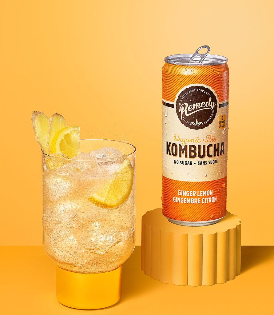 Remedy Kombucha Ginger Lemon can with glass Lifestyle