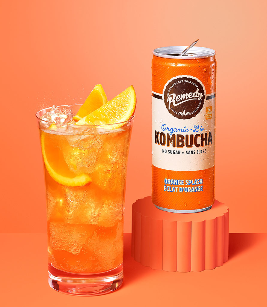 Remedy Kombucha Orange Splash can with glass