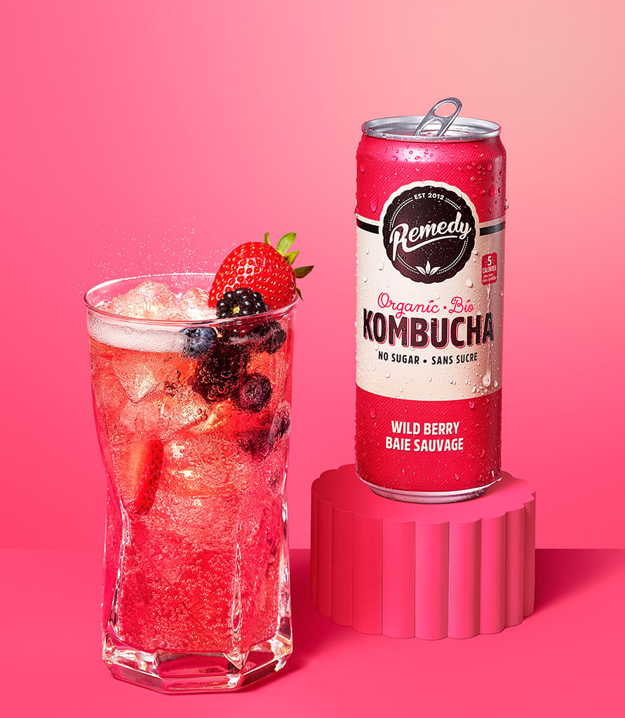 Remedy Kombucha Wild Berry can with glass Lifestyle