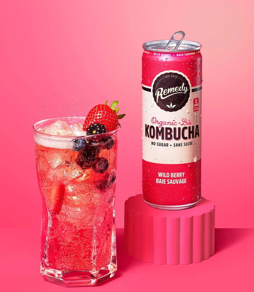 Remedy Wild Berry Kombucha Can with Glass full of Kombucha Lifestyle