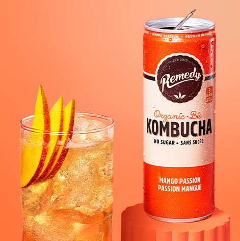 Remedy Mango Passion Kombucha Can with Glass full of Kombucha
